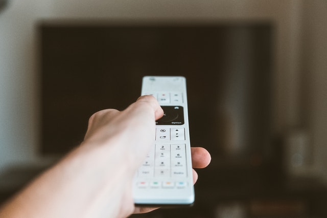 white remote pointed at tv